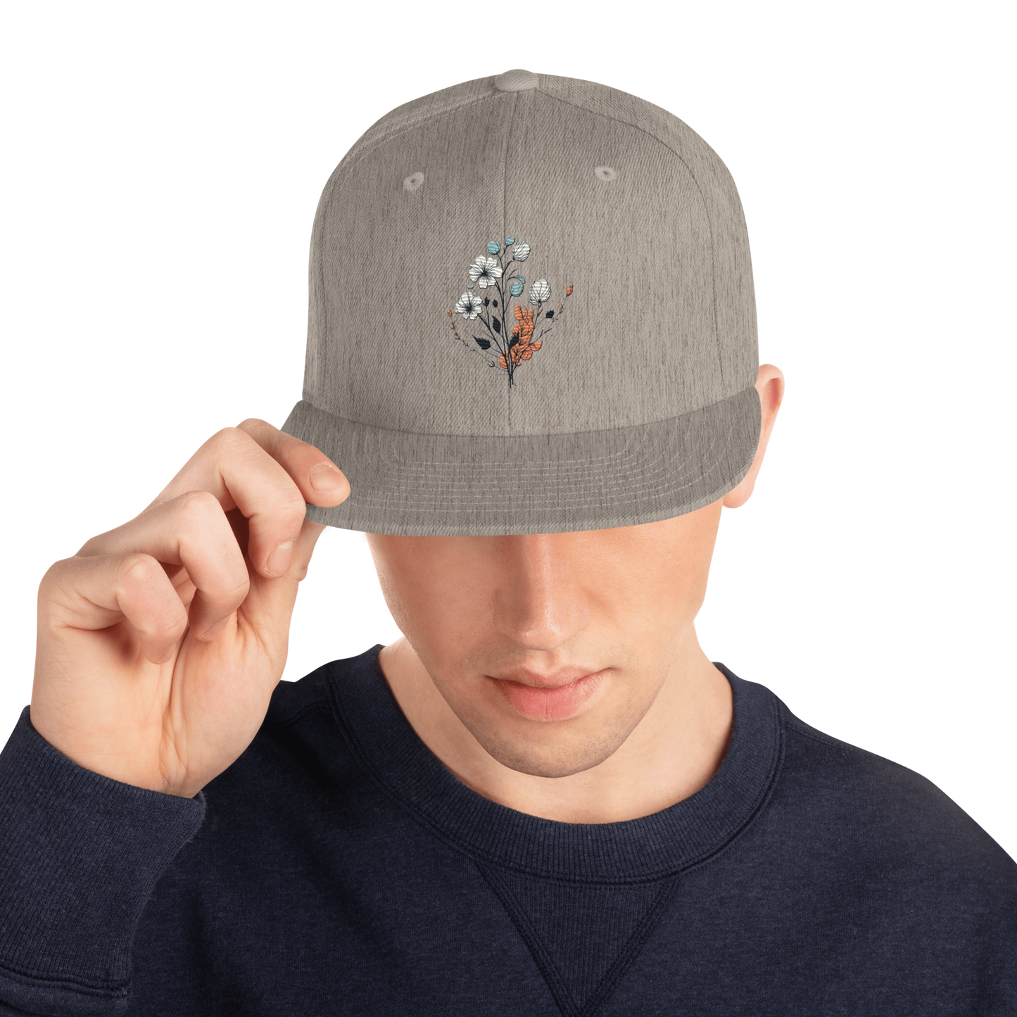 Melerad grå snapback keps med broderad blomdesign framtill
Heather grey snapback cap with embroidered floral design on the front.