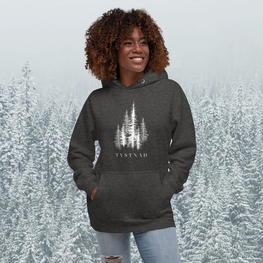Mörkgrå melerad unisex premium hoodie med tryckta granar och texten Tystnad. Charcoal heather unisex premium hoodie with printed pine trees and the word  "Tystnad" on the chest.