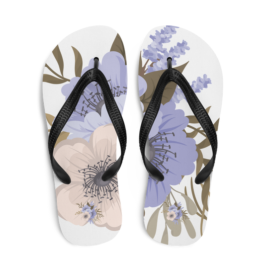 Flip-flops med blommönster i mjuka beige och lavendeltoner, svarta remmar. Flip-lops with floral motif in soft beige and lavender tones, black straps.
