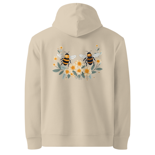 Baksida av sandfärgad unisex ekologisk hoodie med tryck av två bin och gula blommor.
Back view of sand-colored unisex organic hoodie with a print of two bees and yellow flowers.