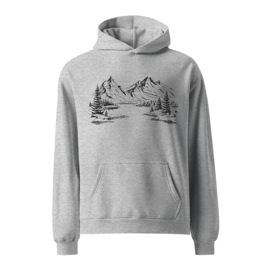 Grå unisex oversized hoodie med handritat fjällmotiv tryckt på framsidan, naturinspirerad design.
Grey unisex oversized hoodie with hand-drawn mountain landscape print on the front, nature-inspired design.